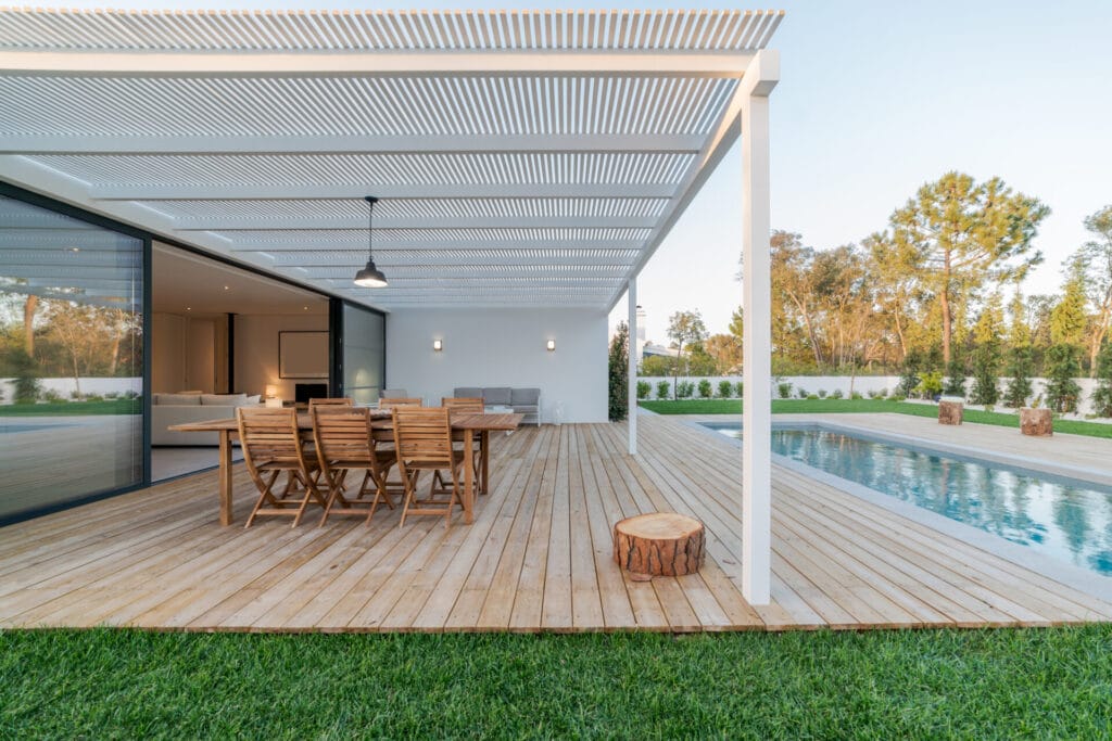 Modern villa with pergola, pool, and deck with interior view