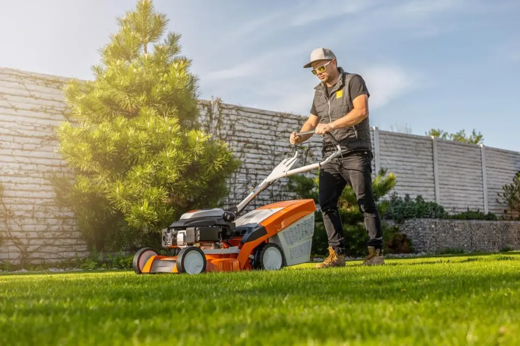 man mowing lawn backyard his house