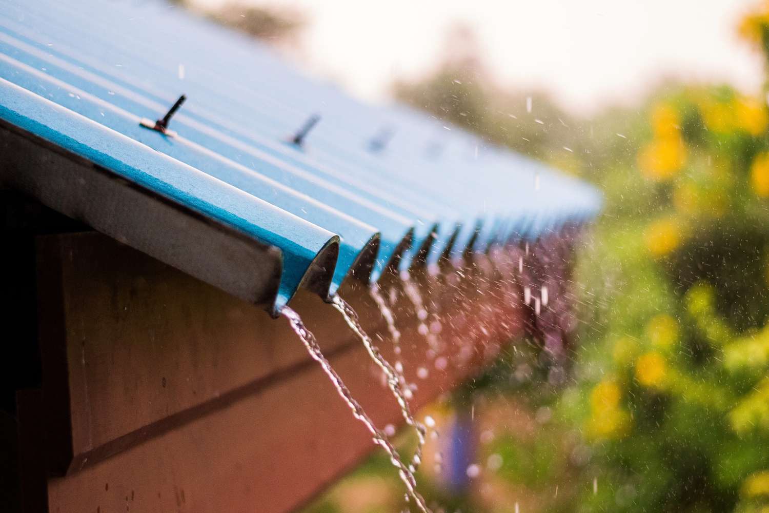 rain water falling from blue roof 1097038754 048d4439036f4d98803b7eeb1e0b48fb