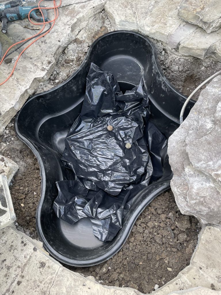 Recent Landscaping Projects In Austin, Tx 5 preformed backyard pond being set into the ground
