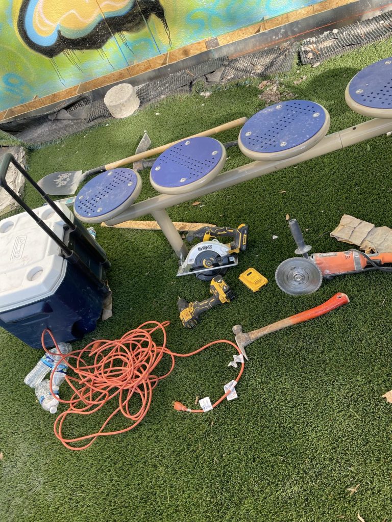 Recent Landscaping Projects In Austin, Tx 8 artificial turf and stepping pads being installed in a play area